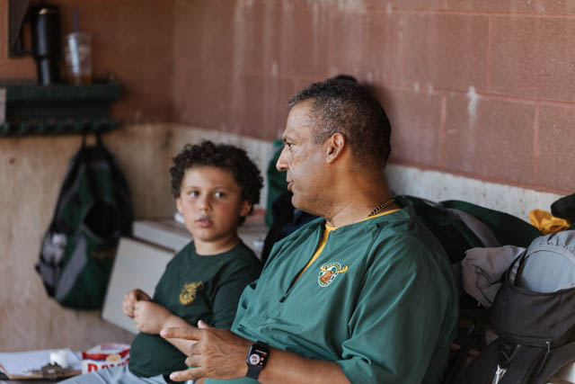 Coach Joshua Guptel in the dugout with his son